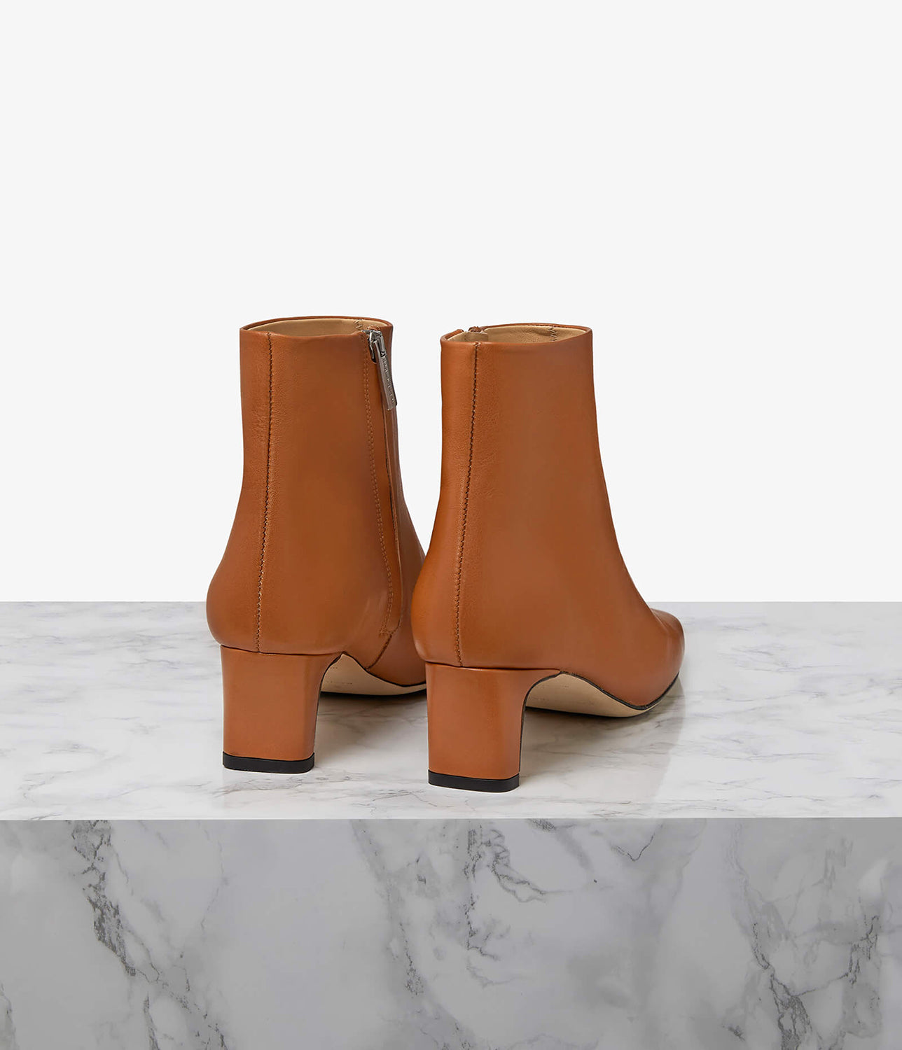 Designed to elevate the everyday, our Parade boot is crafted to a sleek, sculptural silhouette. Choose from a 50mm sculpted or block heel for the perfect amount of lift with ample arch support. Our perfectly placed zip runs all the way down to the arch for easy slip-on, regardless of foot type, while the superior leather options mould to your foot for the perfect fit. Let the modern square toe ground all your daytime looks.