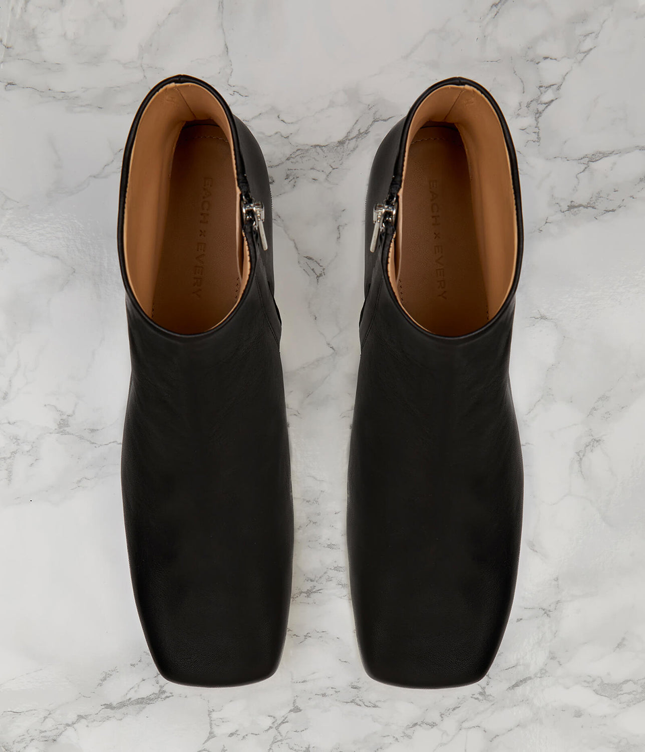 Designed to elevate the everyday, our Parade boot is crafted to a sleek, sculptural silhouette. Choose from a 50mm sculpted or block heel for the perfect amount of lift with ample arch support. Our perfectly placed zip runs all the way down to the arch for easy slip-on, regardless of foot type, while the superior leather options mould to your foot for the perfect fit. Let the modern square toe ground all your daytime looks.