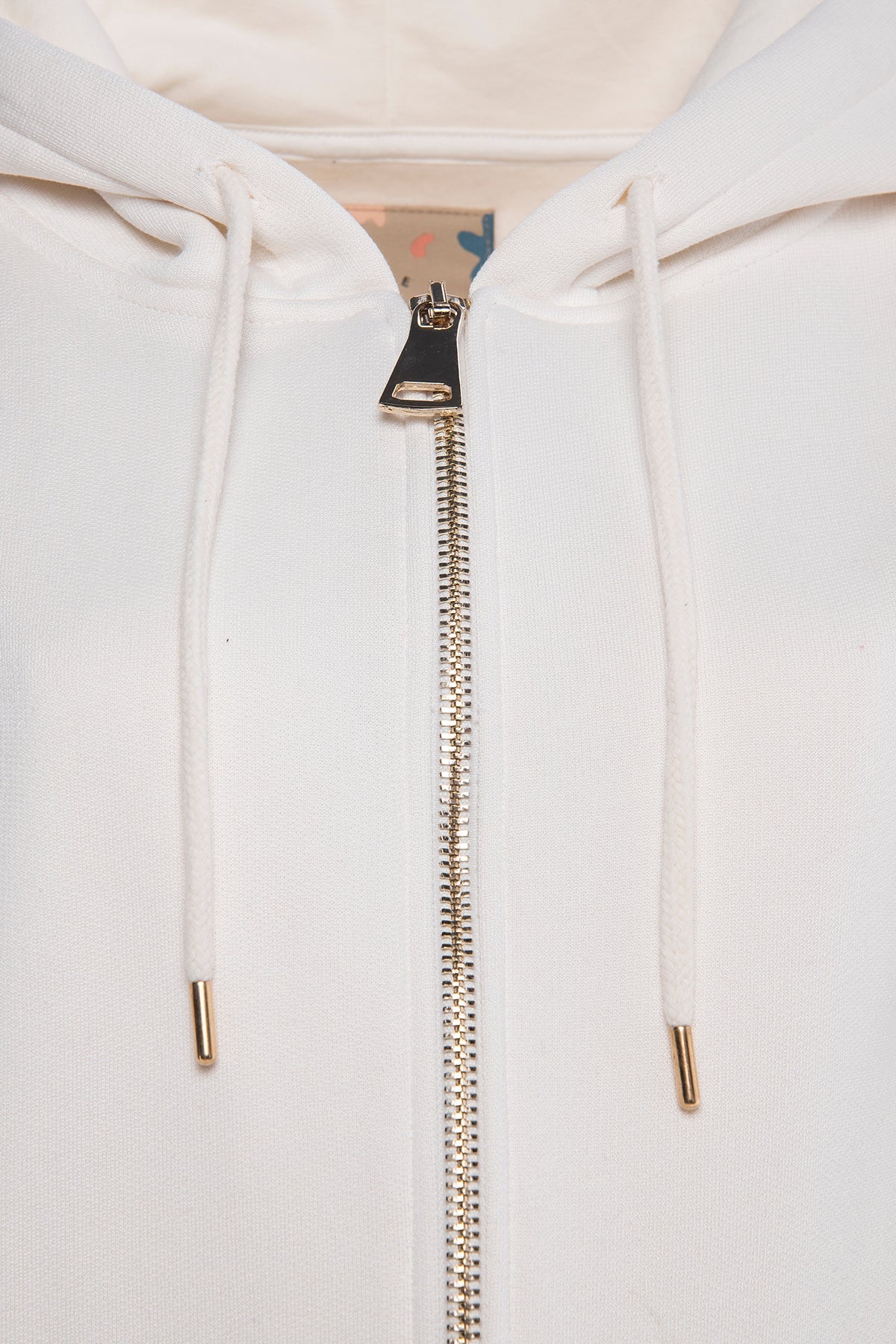 Oversized full-zip hoodie with gold zipper in rice white.