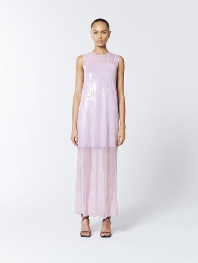 Sheer and shimmering, the SOUR FIGS Sequined Sheer Gown in Wisteria Purple features sequined tulle, a delicate mesh neckline, and a sleek sleeveless cut for a breathtaking evening look.