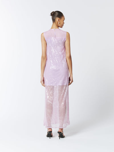 Ethereal and enchanting, this SOUR FIGS Sequined Sheer Gown in Wisteria Purple is crafted from shimmering sequined tulle, featuring a sheer neckline, sleeveless cut, and flowing silhouette.
