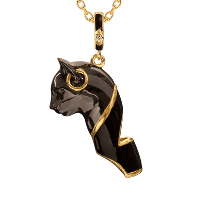Black cat pendant with gold accents on a chain against a dark background