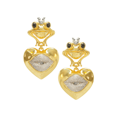 Gold frog-shaped earrings with heart designs on a teal background