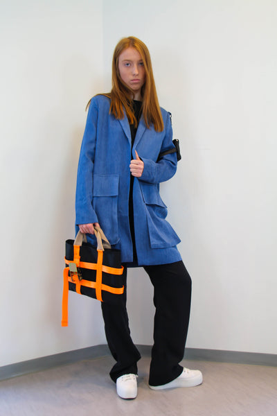 Denim Jacket with oversized pockets on the front and a small leather pocket/bag on the arm.